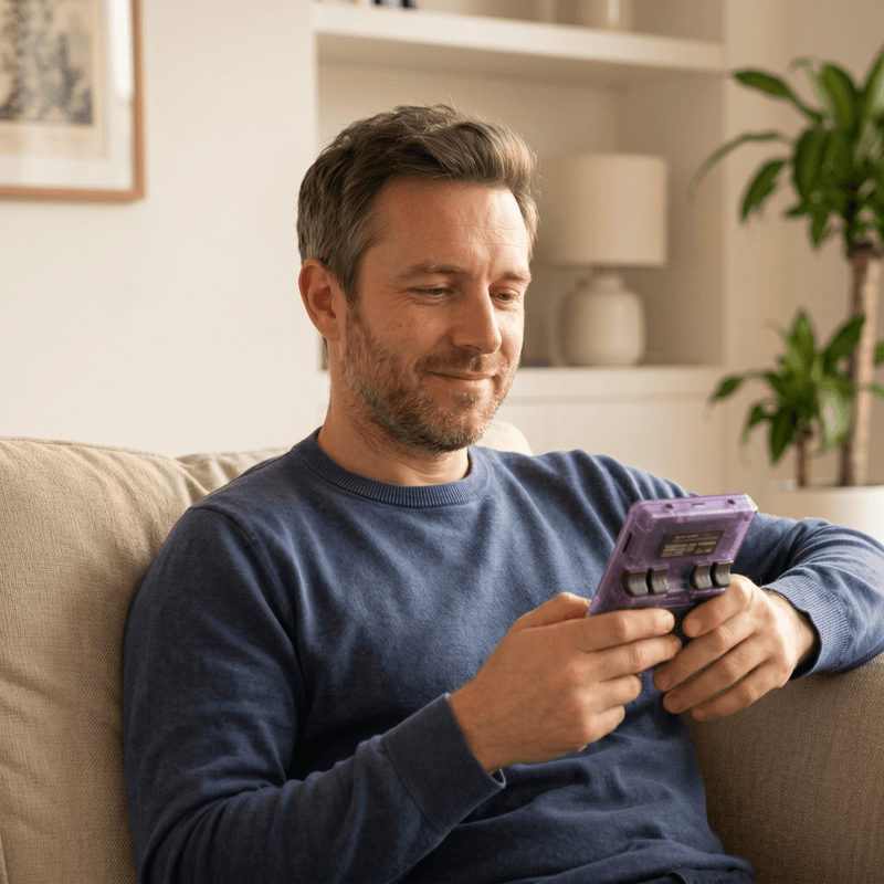 Person playing the Leouyu Pro 2.0 R36S retro gaming console at home